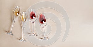 Glasses of red and white wine. Solid beige background