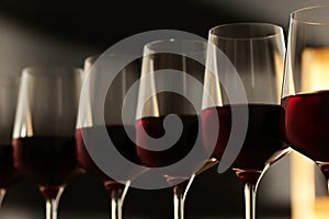 Glasses of red wine against blurred background. Expensive drink