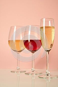 Glasses with red wine on a background of flowers and a mat