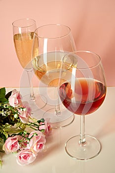 Glasses with red wine on a background of flowers and a mat