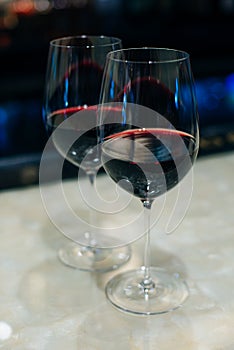 Glasses with red wine on bar counter in restaurante photo