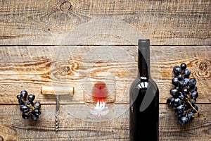 Glasses of red wine and bottle on wooden background top view mockup