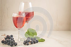 Glasses of red wine and grape over white/red wine and grapes on