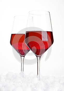 Glasses of red wine on snow balls