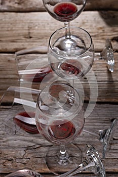 Glasses with the remains of red wine rustic wooden background. Copy of the space. Alcoholic drinks concept. View from above