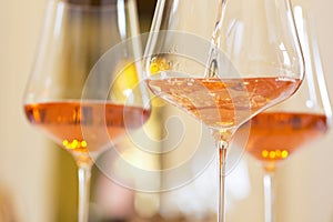 Glasses with rose wine in a festive room for a celebration