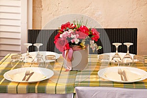 Glasses set served for a festive dinner. Table setting on restaurant summer terrace. Glasses, fork, knife served for dinner in