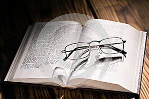 Glasses shadow on open book