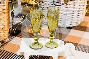 Glasses of sparkling champagne near the Christmas tree, garland and Christmas decoration. Christmas and New Year