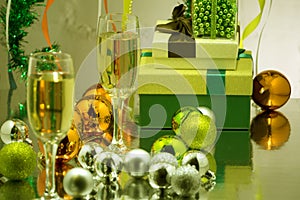 Glasses with sparkling wine on the background of the decorated Christmas tree. Garland with lights, glittering tinsel. Holiday Chr