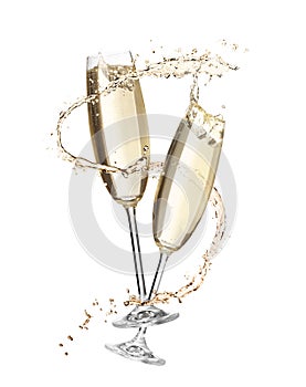 Glasses with sparkling wine and splashes on white background