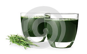 Glasses of spirulina drink and wheat grass