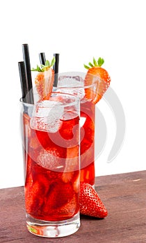 Glasses of strawberry cocktail with ice on old wood table