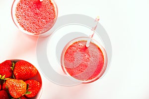 Glasses of strawberry milkshake or smoothie. Summer healthy vitamin beverage, diet or vegan food. Top view