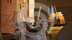 Glasses on a table at a restaurant. The restaurant`s interior. T