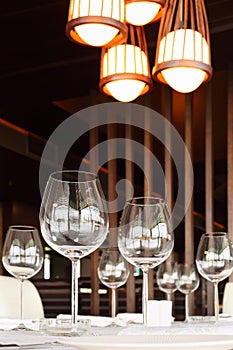 Glasses at table with tablecloth in restaurant photo