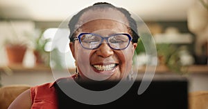 Glasses, tablet and senior black woman on a sofa reading ebook, social media or funny gif at home. Digital, app and face