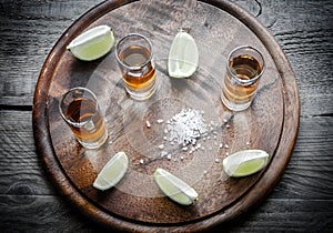 Glasses of tequila on the wooden board photo