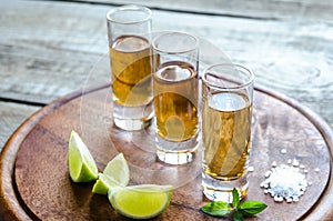 Glasses of tequila on the wooden board photo