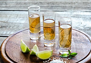 Glasses of tequila on the wooden board photo