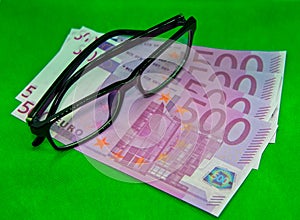 Glasses on top of euro bills