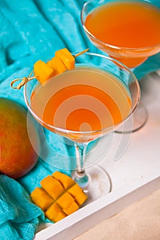 Glasses of tropical exotic multifruit mango juice cocktail drink on the white tray. Tripical beach picnic concept photo
