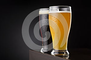 Glasses of unfiltered wheat beer and dark beer photo