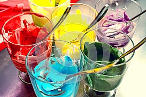 Glasses of various food coloring