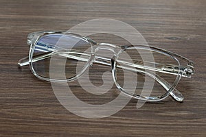 Glasses for vision with dioptria on the wooden table office photo