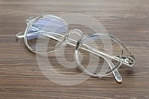 Glasses for vision with dioptria on the wooden table office photo