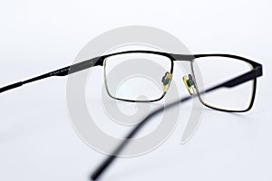 Glasses for the visually impaired, poorly sighted.glasses with aspherical astigmatic lenses  in black frame on a white background.