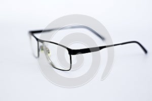 Glasses for the visually impaired, poorly sighted.glasses with aspherical astigmatic lenses  in black frame on a white background.