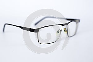 Glasses for the visually impaired, poorly sighted.glasses with aspherical astigmatic lenses  in black frame on a white background.
