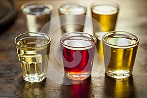 Glasses of vodka on a wooden table.