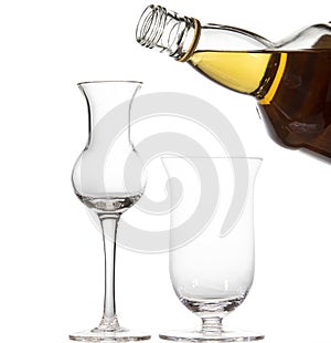 Glasses for whiskey and a bottle isolated on white background
