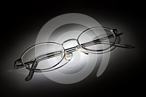 Glasses on white background in the darkness