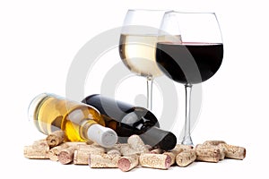 Glasses of white and red wine and corks