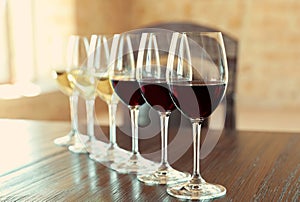 Glasses of white and red wines photo