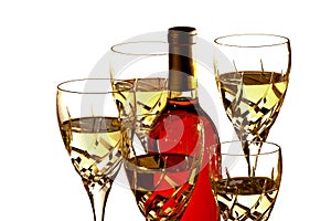 Glasses with white wine around bottle of red wine