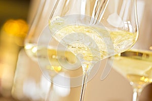 Glasses with white wine in a festive room for a celebration