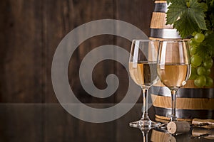 Glasses of wine with barrel and grapes