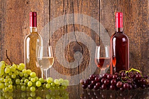 Glasses of wine with bottles and grapes