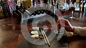 Glasses of wine and cheese plate. Wine testing. Wine test, crystal glass, red wine, cheese, bar counter background.