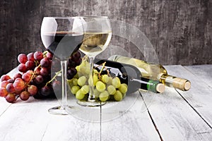 Glasses of wine and grapes on wooden background. red and white w