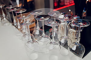 Glasses of wine. Glasses hanging above the bar in the restaurant. Empty glasses for wine. Wine and martini glasses in