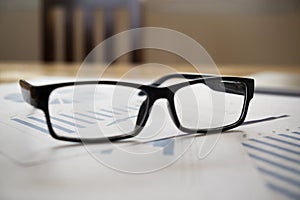 Glassess of financial reports.