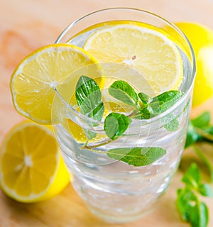 Glasss of mojito with lemon and drinking straw