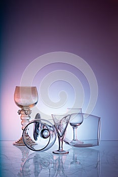 Glassware on abstract diffuse background in pink blue tones