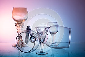 Glassware on abstract diffuse background in pink blue tones