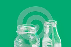 Glassware crystal bottle jar on green background. Reusable materials plastic-free alternatives zero waste environmental protection